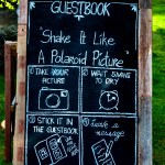 Wooden guestbook sign written by hand in chalk
