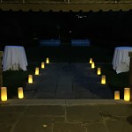 Candle decorations in outdoor wedding reception at night