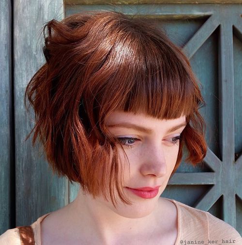 short red wavy bob with bangs