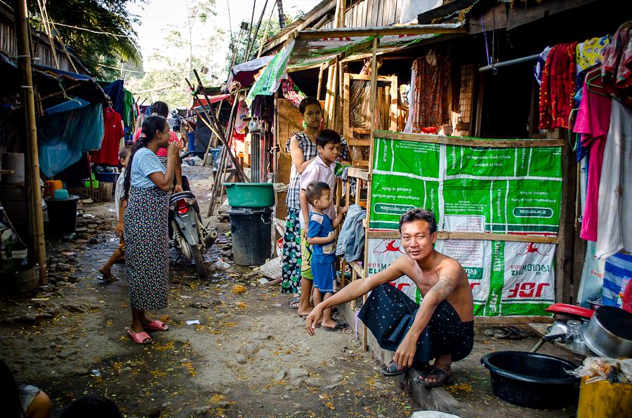 A man sits outside his simple home in Myawaddy, Myanmar. 