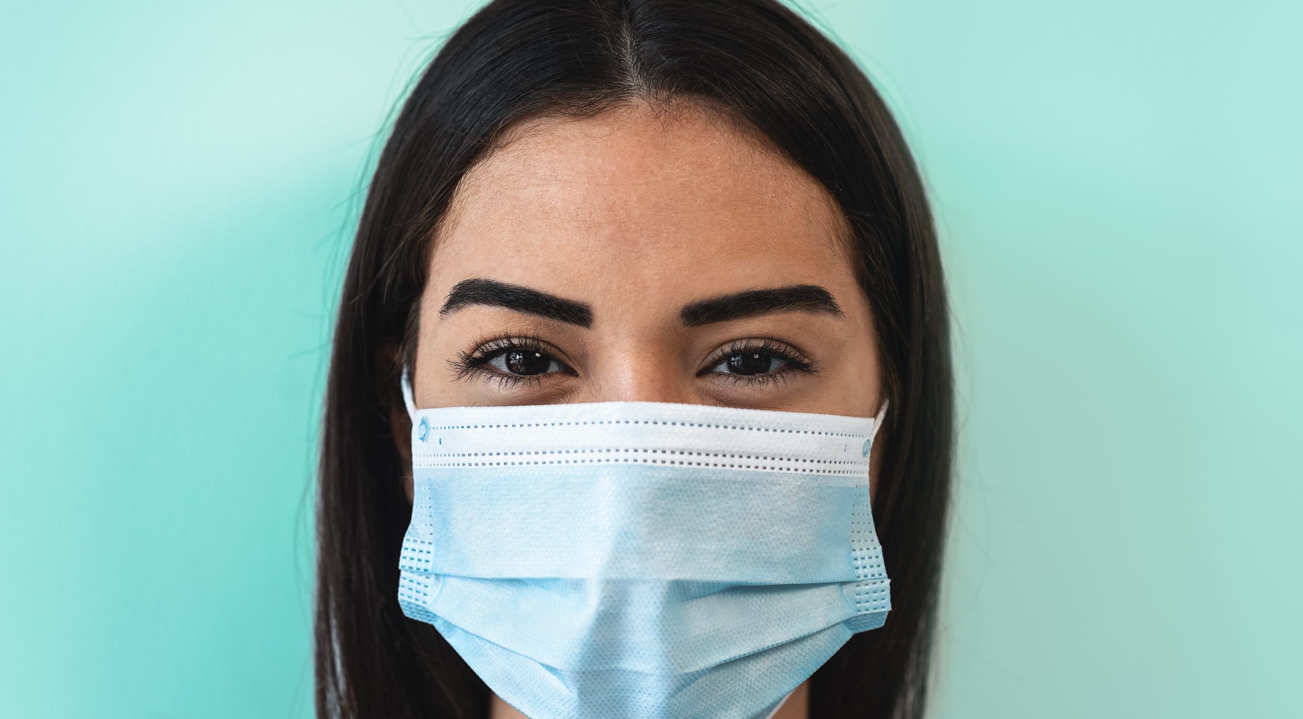 Young woman wearing face surgical mask Young girl using facema