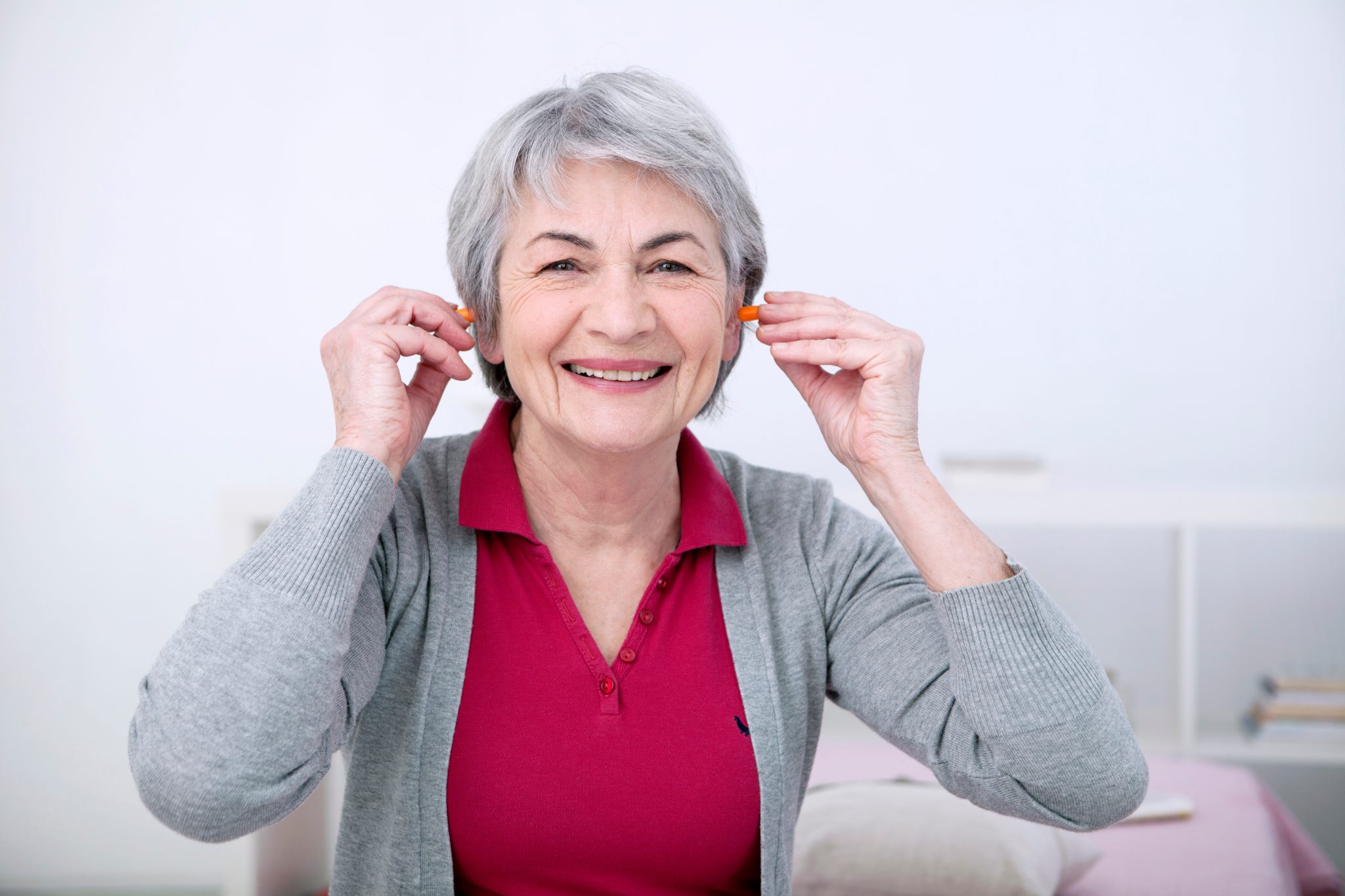 How should one properly insert and use ear plugs?