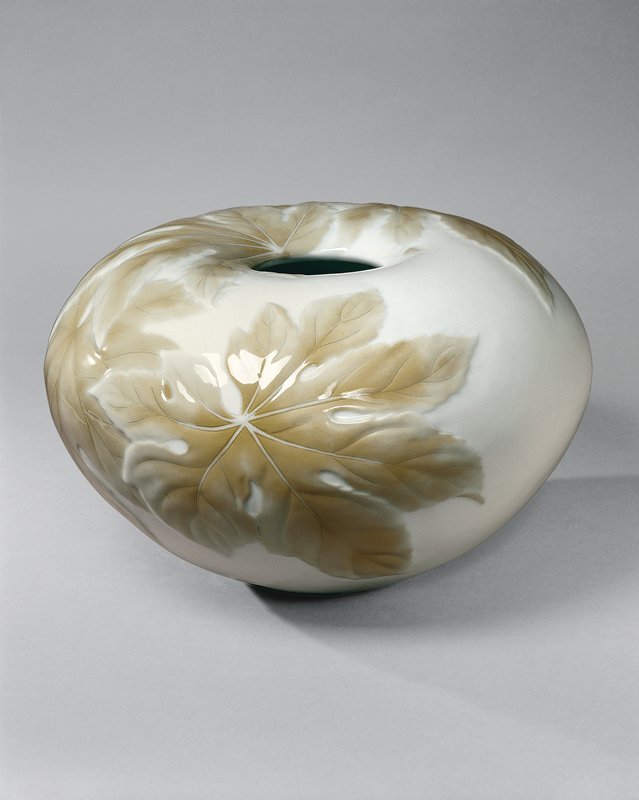 White porcelain round vase with low relief design of green leaves