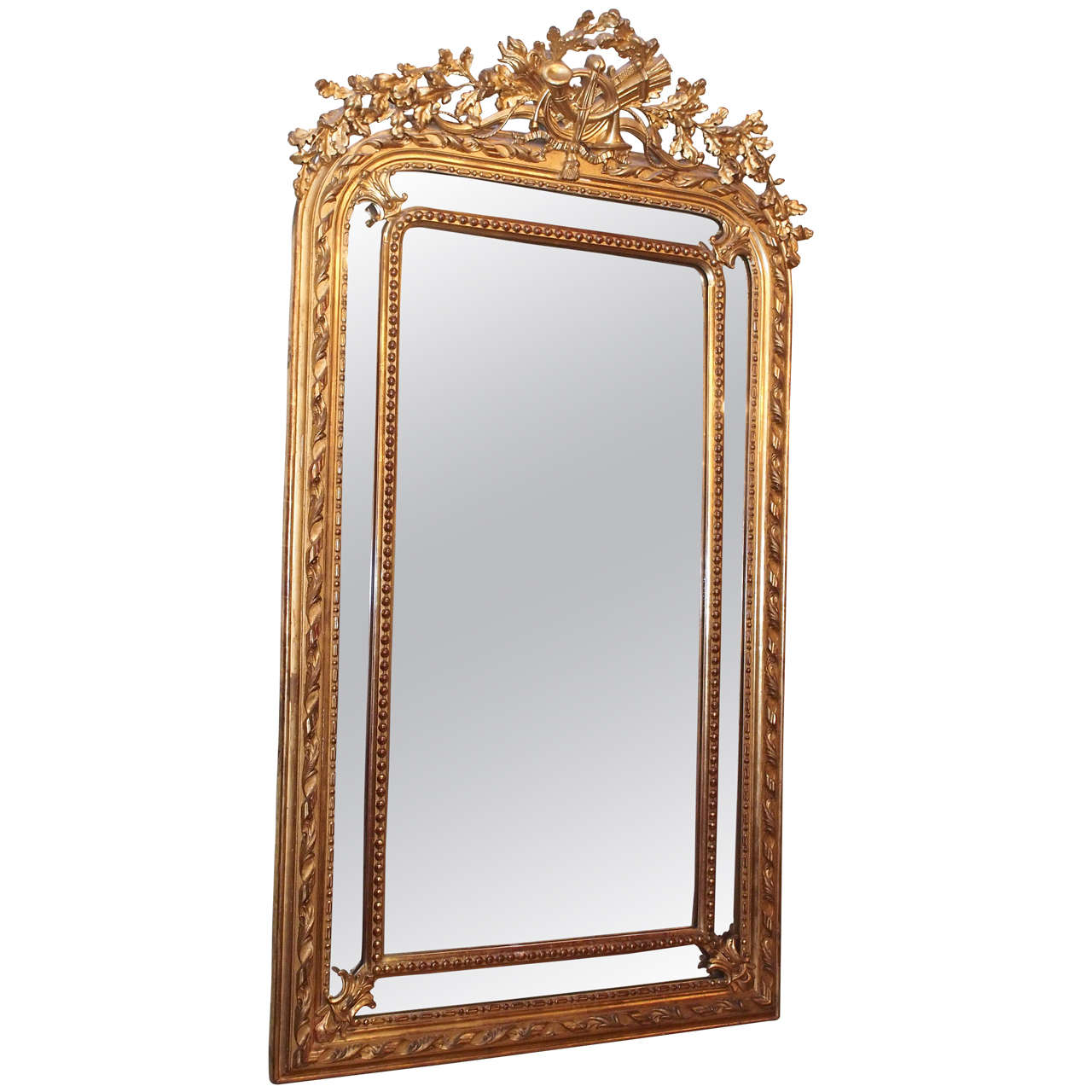 Antique French gold leaf cushion mirror with "music" crest. Period