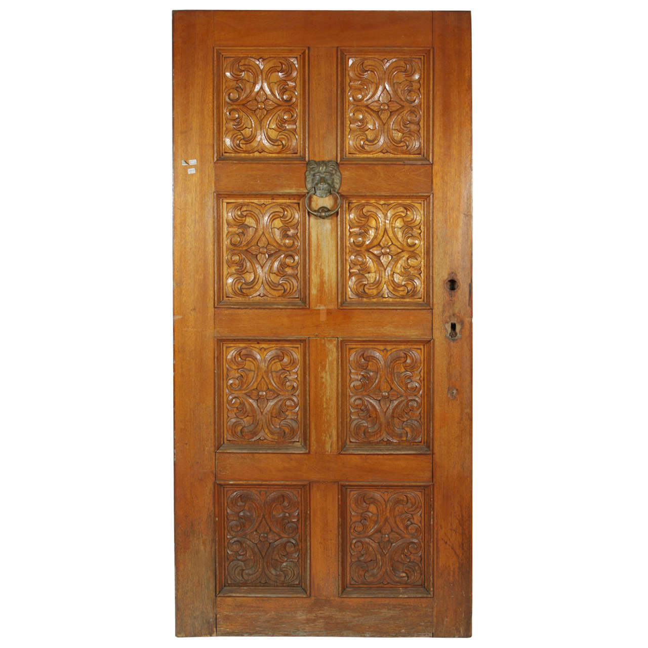 Carved Wooden Spanish Style Entry Door with Bronze Doorknocker at