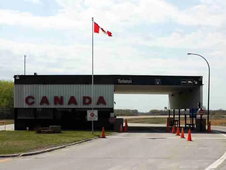 Does Wisconsin Border Canada? A Bus On a Dusty Road