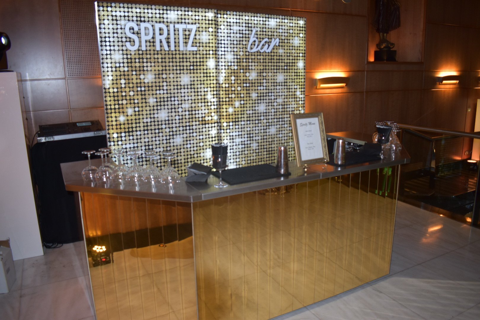 A gold mobile bar and golden event backdrops for this Glitz and Spritz