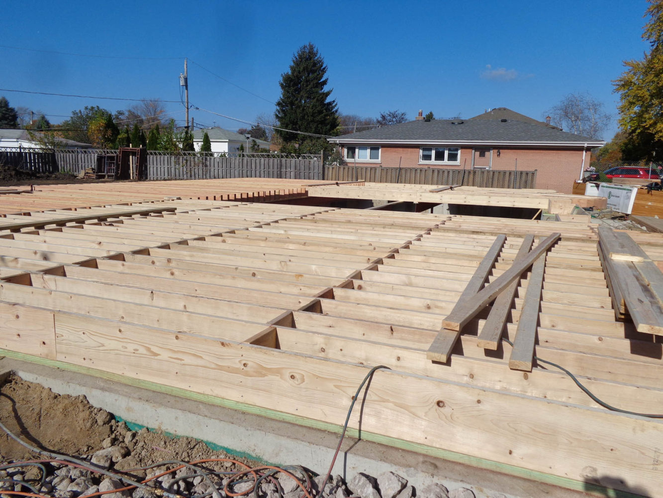 Framing the first floor decking at Mango America's Custom Home