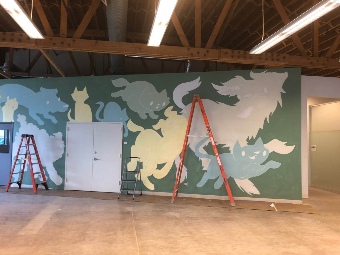Dogs and cats are being painted on the new mural at the