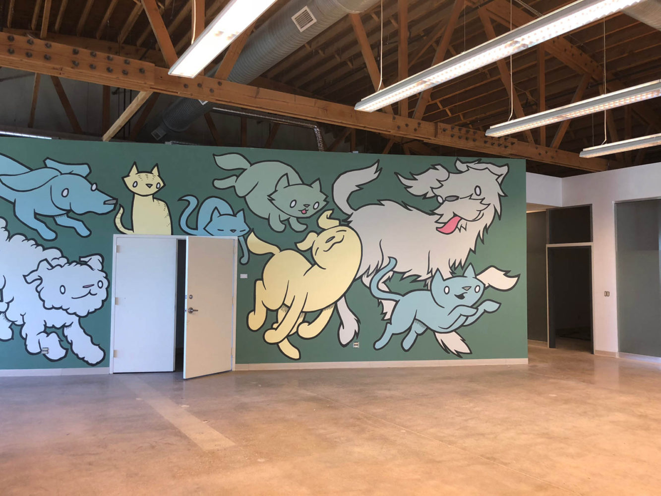 Dogs and cats are being painted on the new mural at the animal shelter