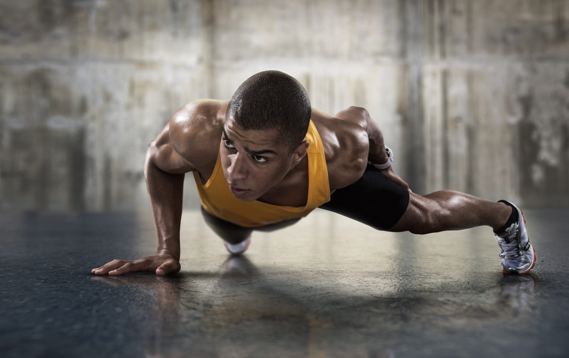 Sport. Young athletic man doing pushups. Muscular and strong guy