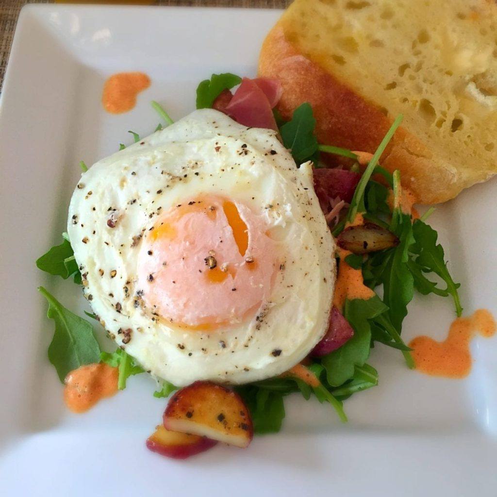 Sunny Side up Egg, over Arugula, Red Pepper Cream, SautÃ©ed Potatoes