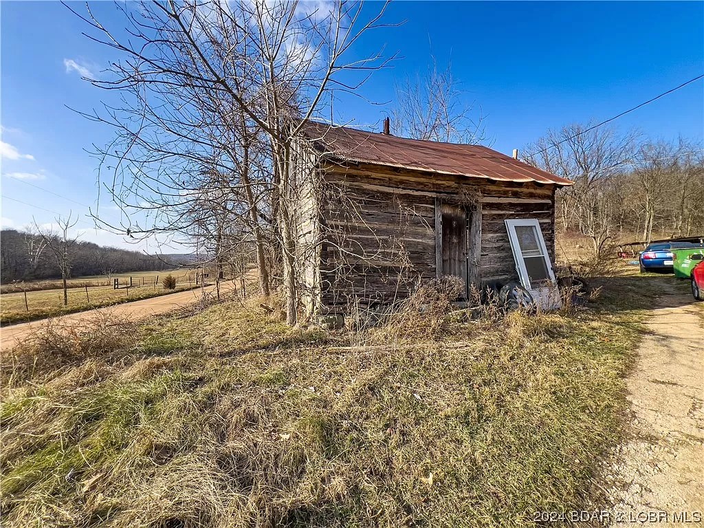 Outside city limits. Wooded 12.4 acres w/ 3 bd/2ba ranch home and more