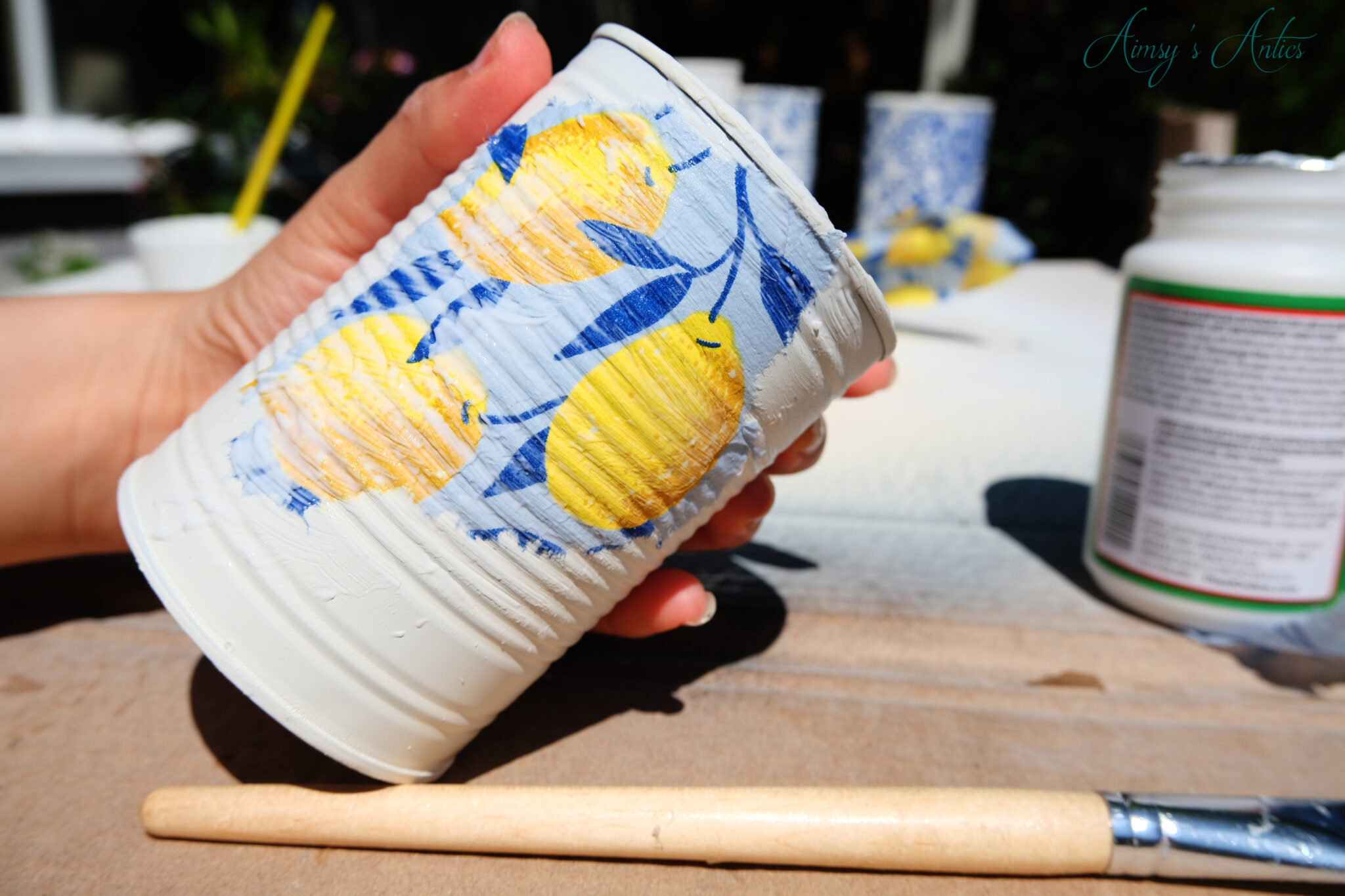 Piece of napkin decoupaged onto the tin can