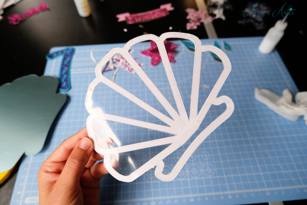 Acetate attached the to mermaid shell outline