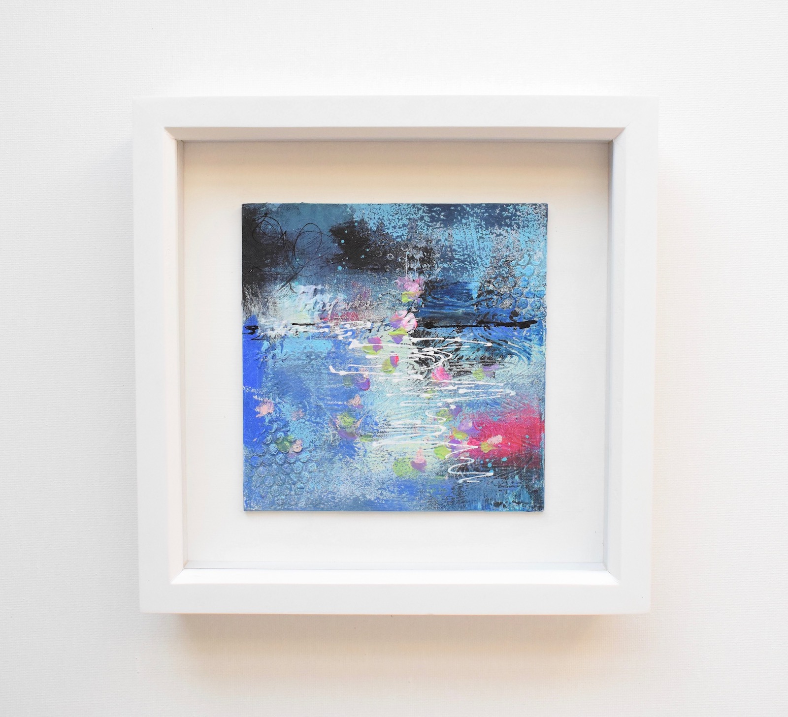 Small, blue, mixed media art, in white frame blue abstract water