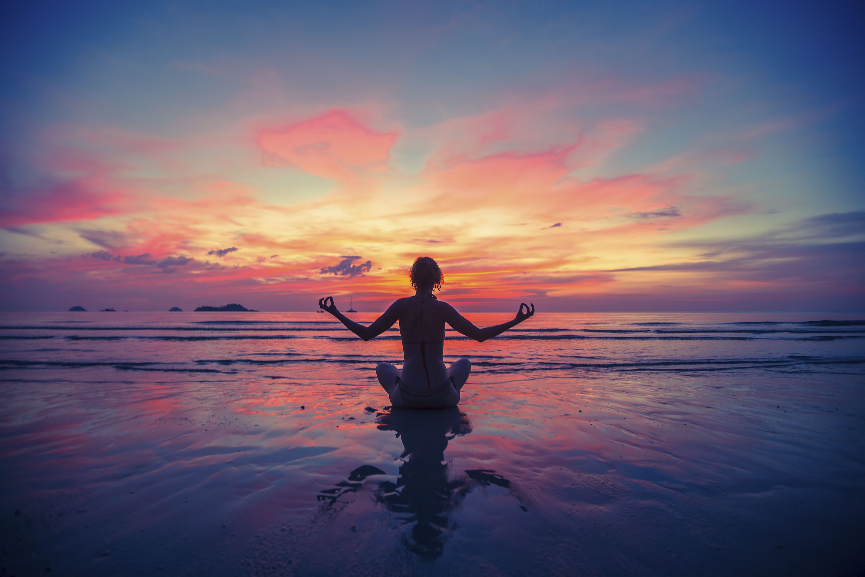 Woman doing meditation near the ocean beach. Yoga silhouette. * Alisoun