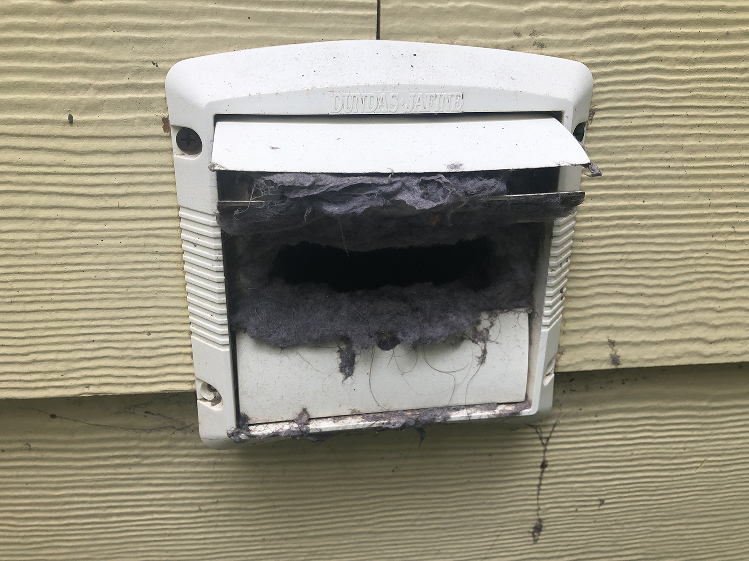 LINT ACCUMULATION AT EXTERIOR DRYER VENT All Islands Home Inspections
