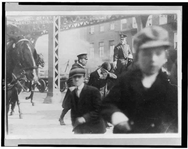 Policemen Arresting Striker