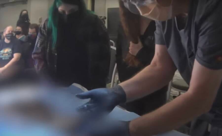 Autopsy Attendees Touching Body