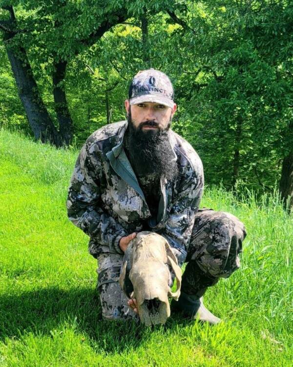 Kevin Adkins Holding Sloth Skull