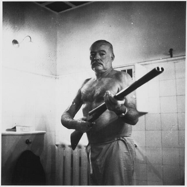 Ernest Hemingway Holding A Shotgun