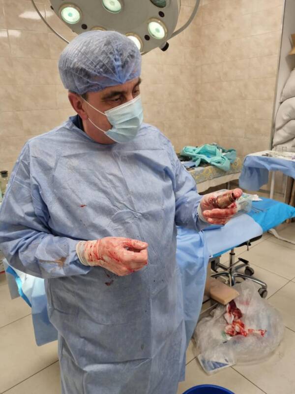 Doctor Holding Removed Grenade