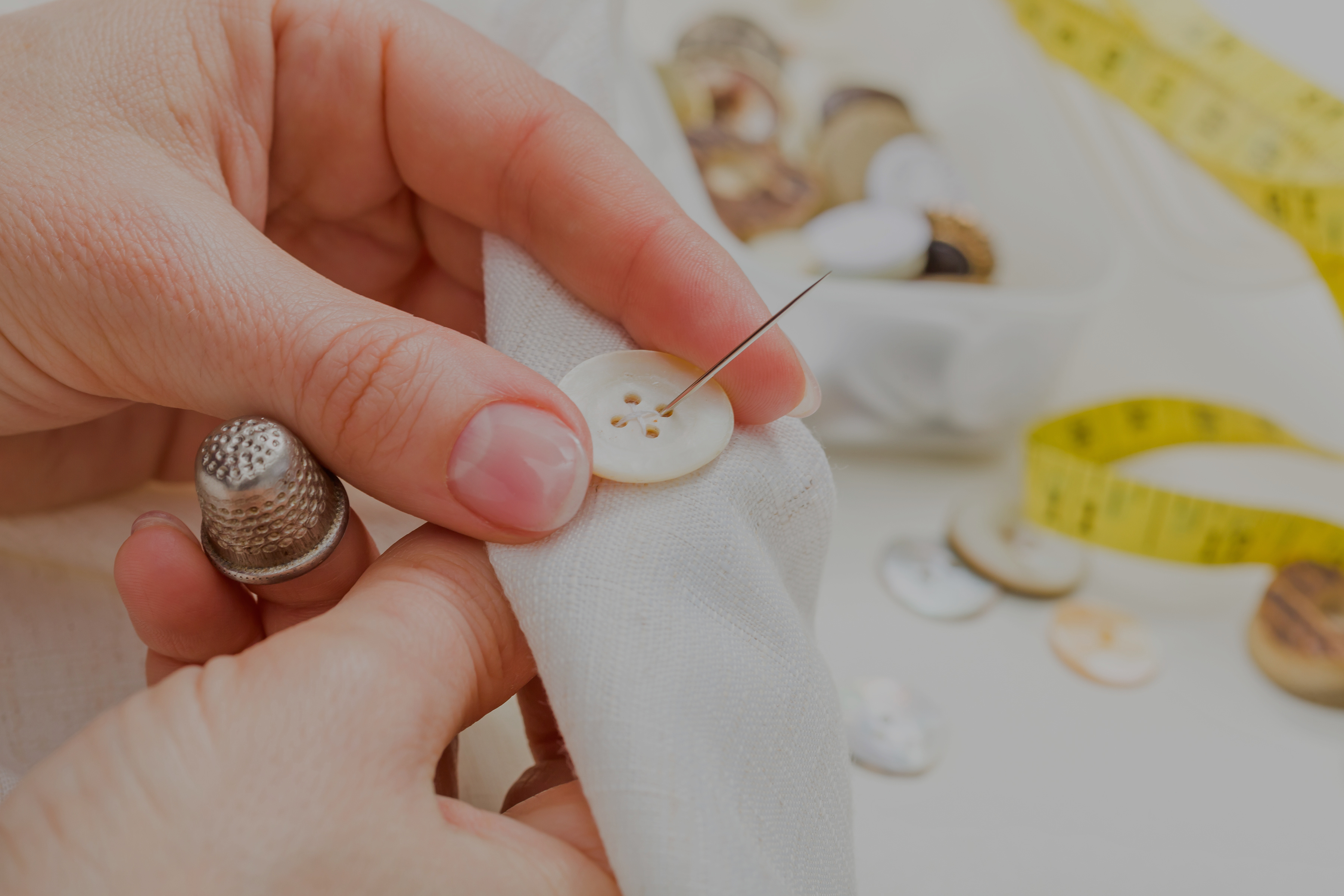 Sewing button on cloth Alteration Services Singapore