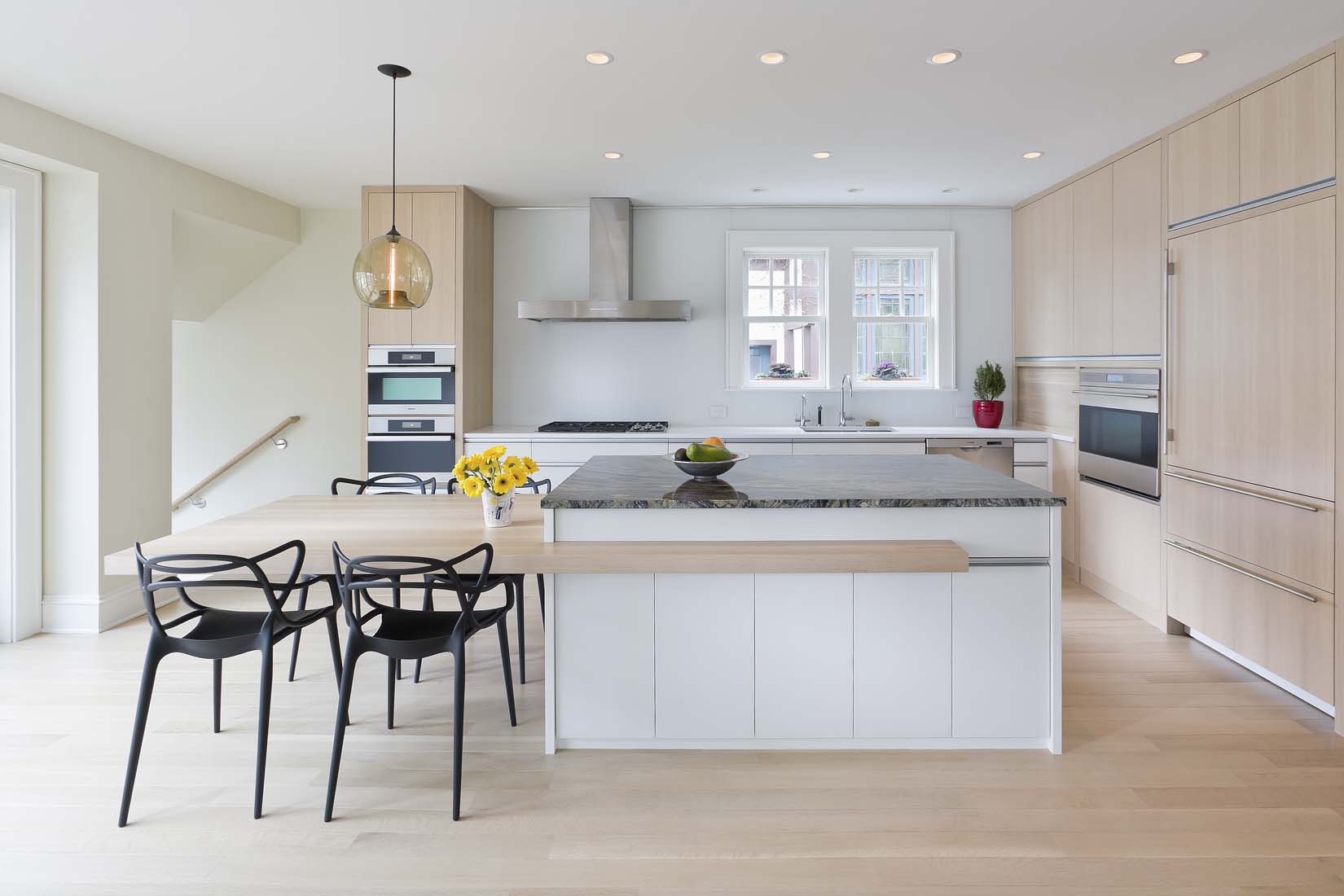Modern upscale kitchen with light wood floor and Andrea Rugg