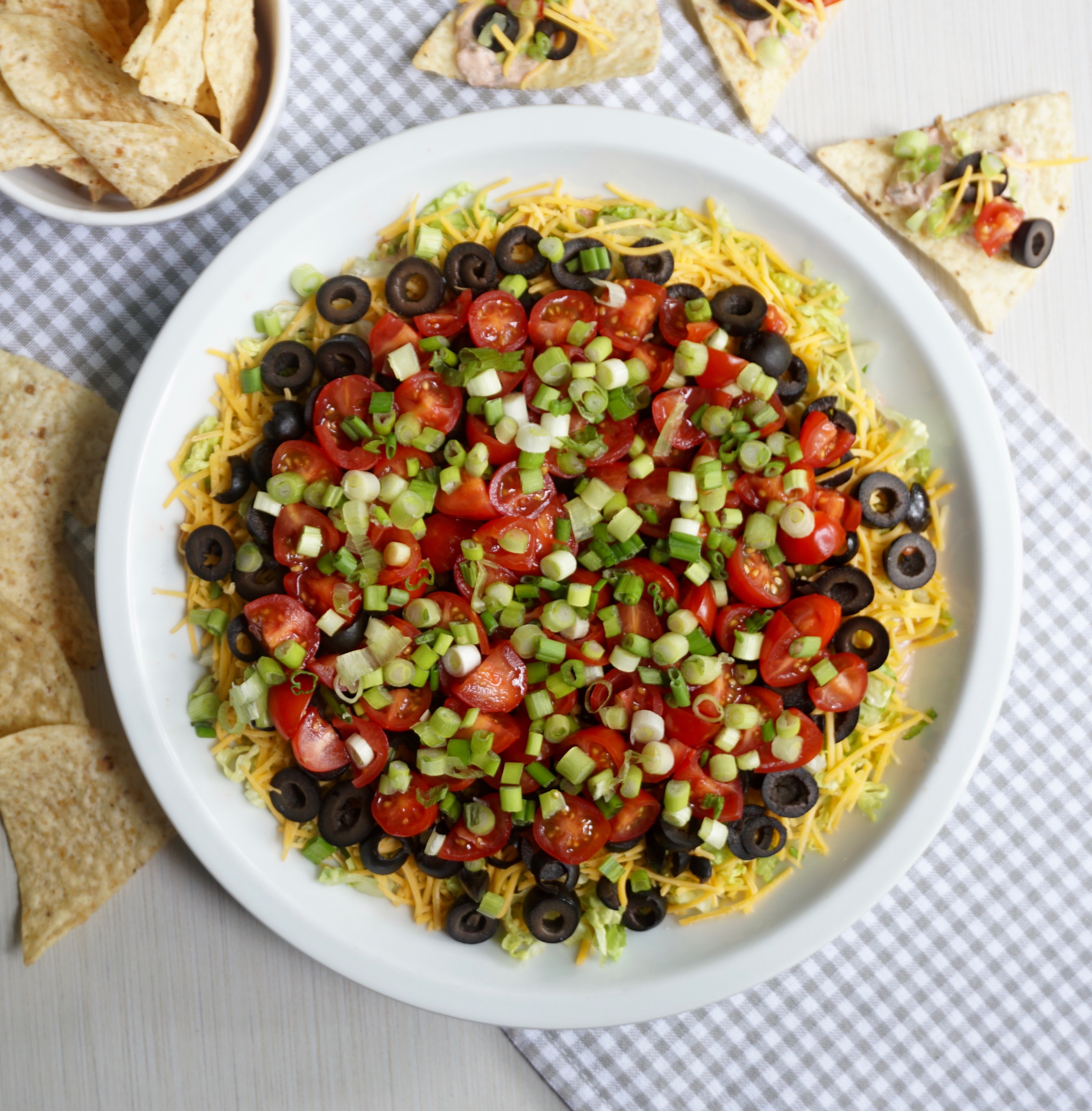 Taco Dip combines salsa and sour cream and is topped with fresh veggies.