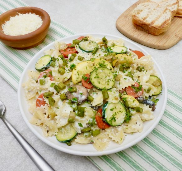 Farfalle Primavera is a creamy pasta dish with lots of vegetables.