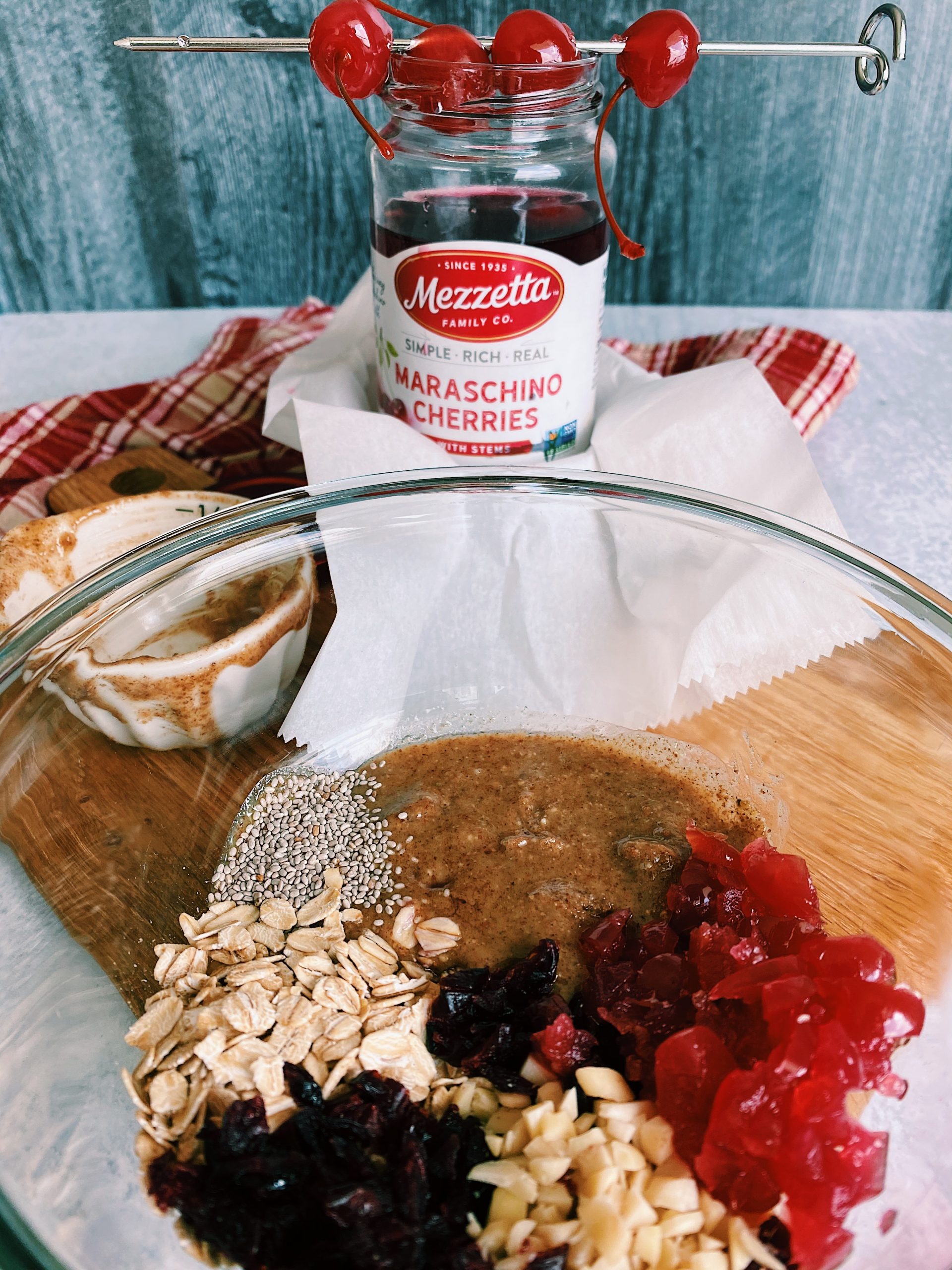 Cherry ball ingredients in glass mixing bowl.