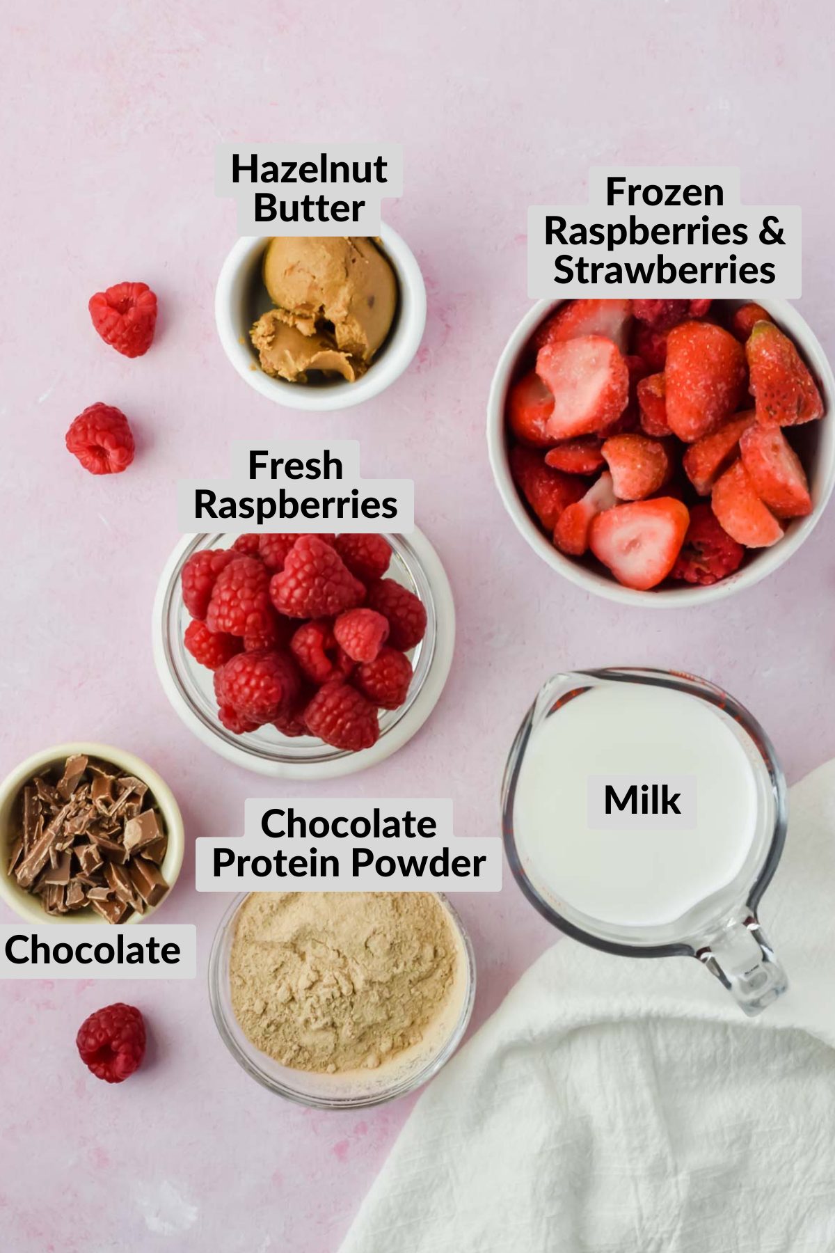 labeled chocolate raspberry smoothie ingredients in individual bowls.