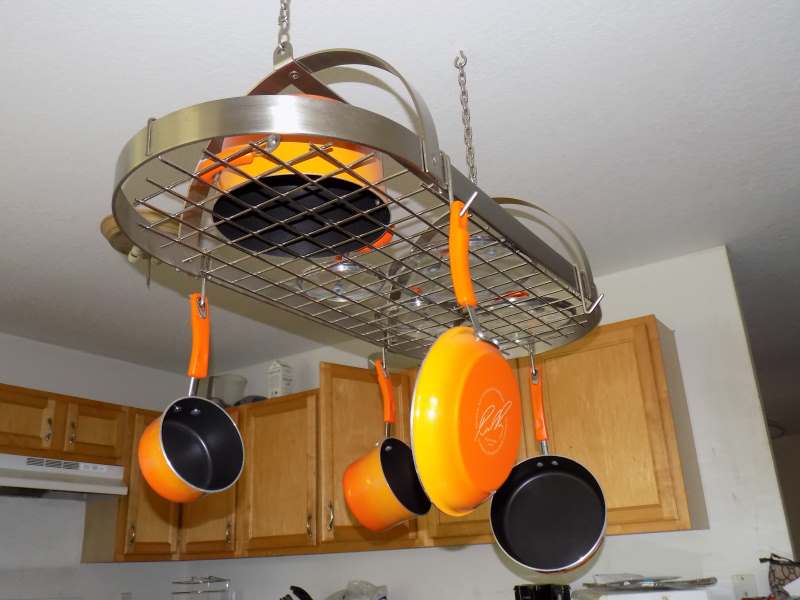 Brushed Nickel Oval Pot Rack Installed holding Orange Rachel Ray Pots