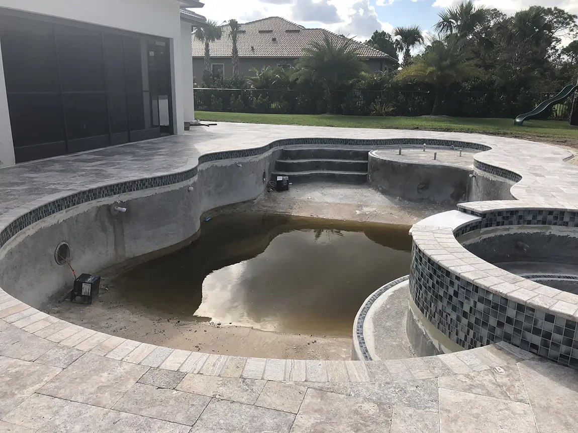 Swimming gPool Resurfacing with pavers installation in Aruba by Aquatic