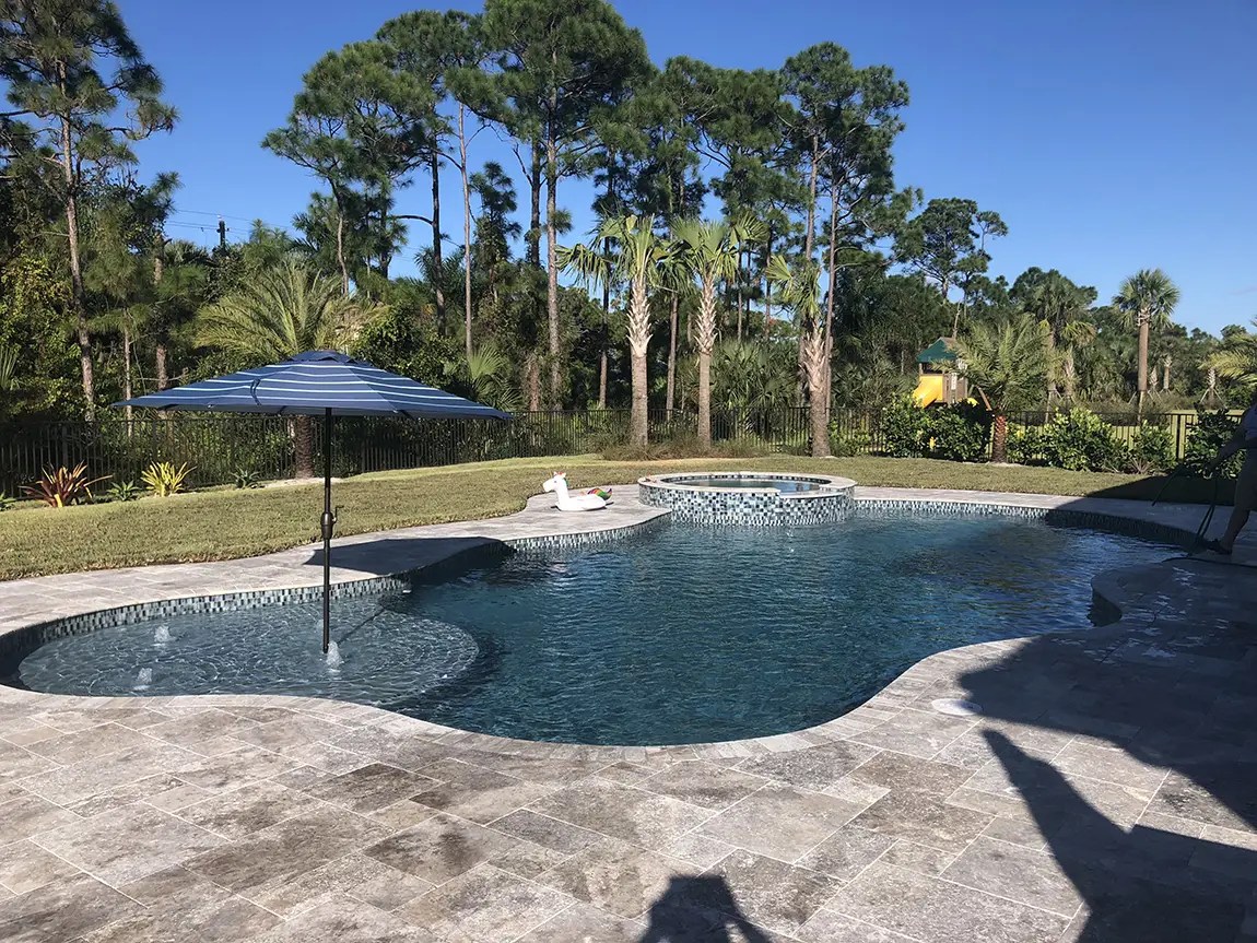 Swimming gPool Resurfacing with pavers installation in Aruba by Aquatic