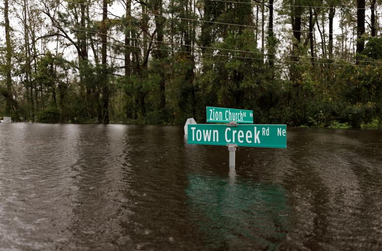 Street signs are mostly submerged by rising flood waters in the aftermath of Hurricane Florence