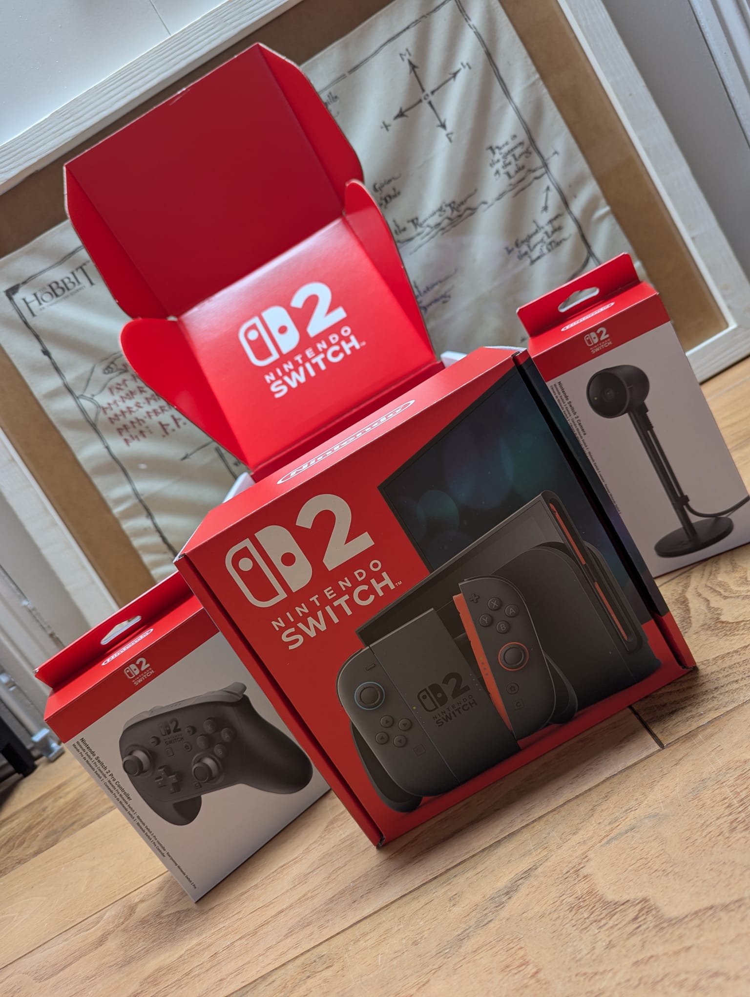 A photo of Switch 2 hardware boxes resting on a wooden floor. Bertie's delivery is here.