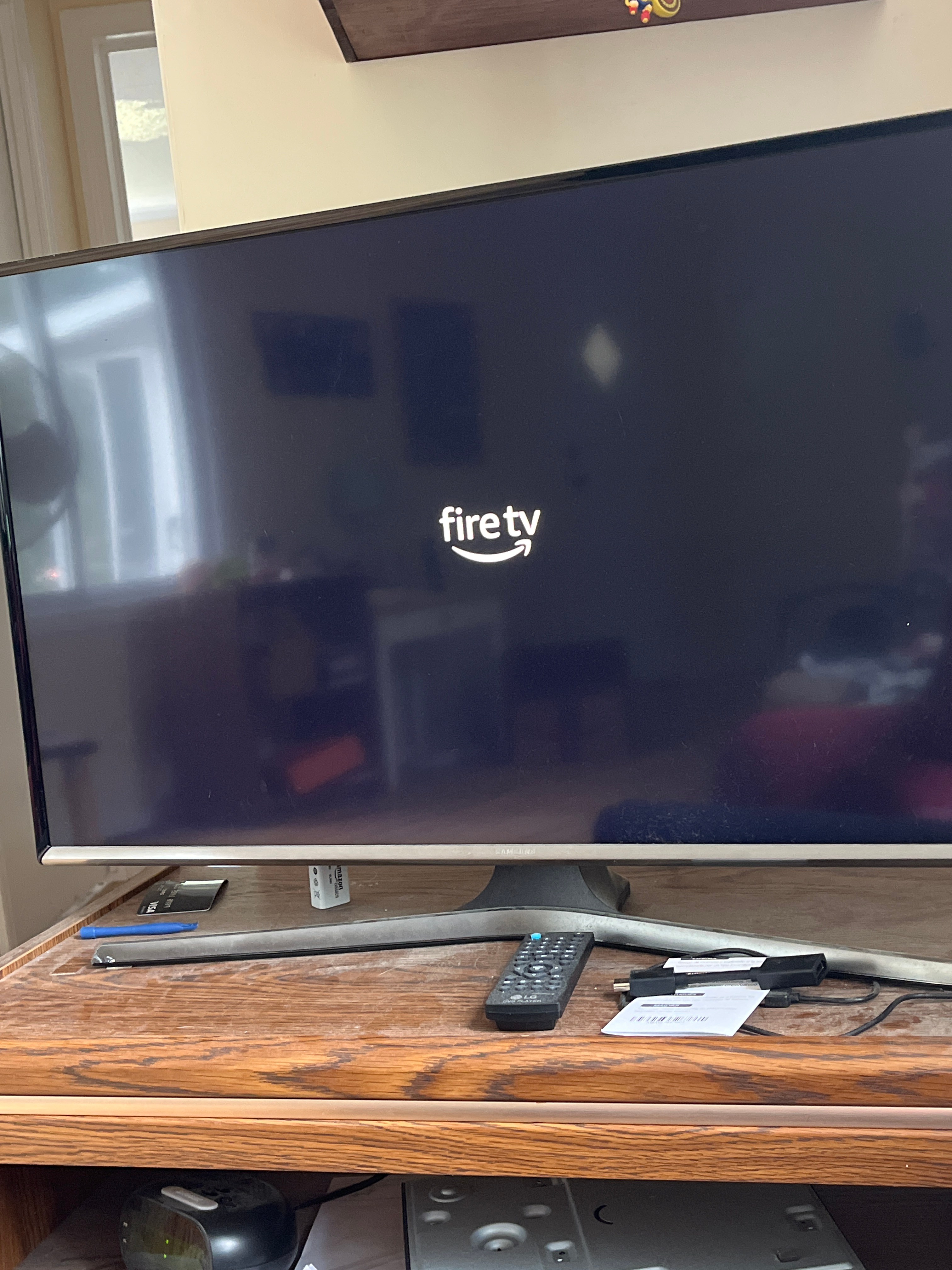 Why is my tv stuck on a black screen with Fire TV logo?