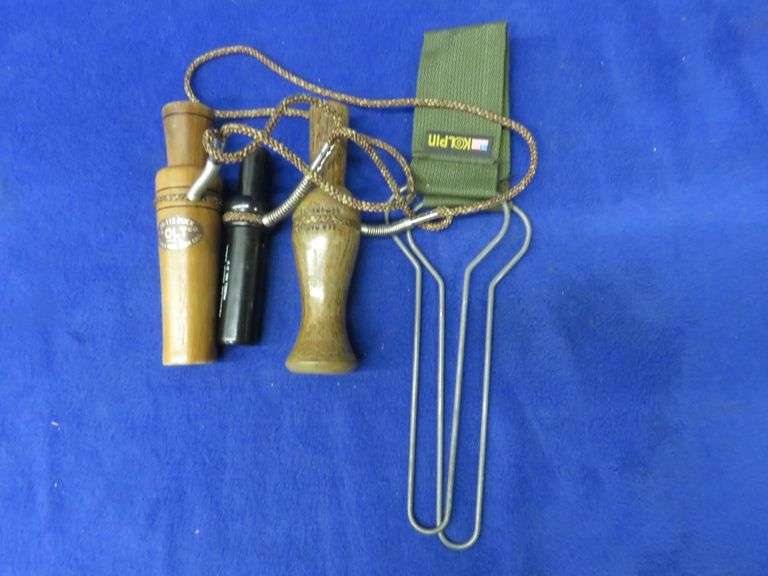 One goose call and two duck calls and a duck strap AAA Auction and Realty