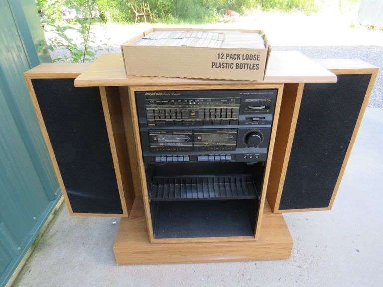 Soundesign stereo with dual cassette player and foldin speakers and a collection of
