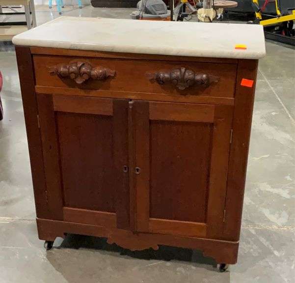 Marble top washstand on wheels, 30x15x32”, one door does not stay