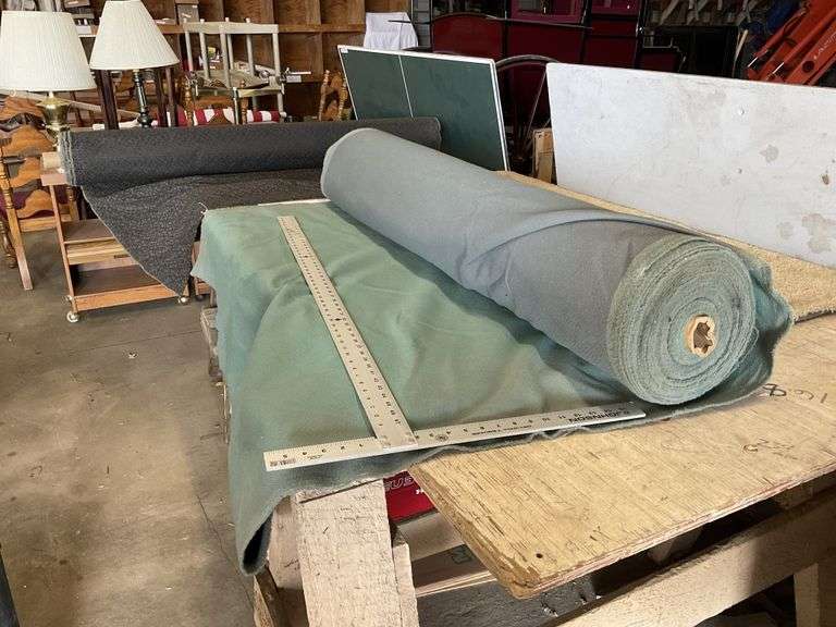 Roll of green fabric and black fabric Legacy Auction Company