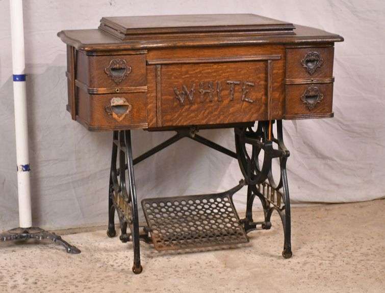 White vintage sewing machine with oak case on iron stand; 10186011 R.H. Lee & Co. Auctioneers