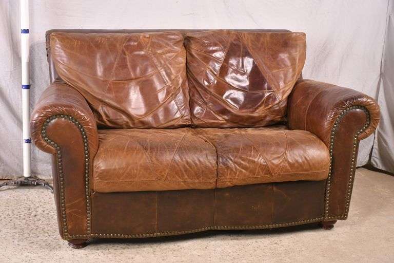 Brown leather loveseat with brass nail head trim; 7410043 R.H. Lee