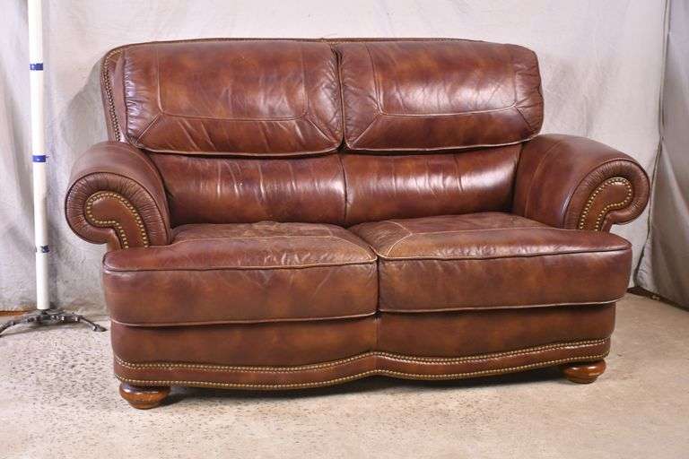 Brown leather loveseat with brass nail head trim; 7410213 R.H. Lee