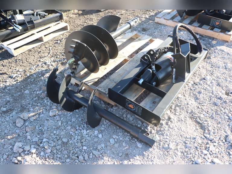 Unused Wolverine hydraulic auger with 12" & 18" bits for skid steer