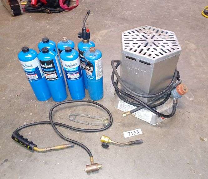 Propane heater, seven small propane tanks, propane torches. Mark Van