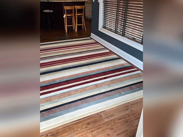 Area rug with pad10’2” x 8’ Northern Kentucky Auction, LLC