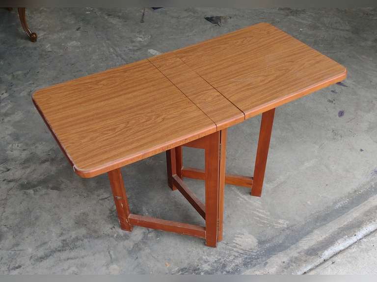 Fold up table approximately 16" deep, 31" long, 20" tall. 3 1/2" wide